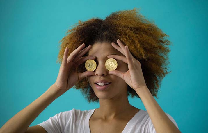 female holding bitcoins